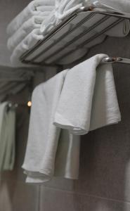 a group of towels hanging on a rack in a bathroom at Daol Guesthouse in Seoul