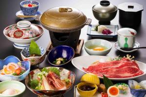 a table with many bowls of food on it at New Ogiya in Fukushima