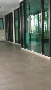 an empty building with glass doors and a concrete floor at Abani Inn in Jomtien Beach +3 photos