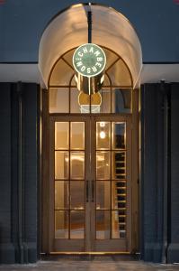 a clock hanging over the door of a building at The Chamberson in Dunedin