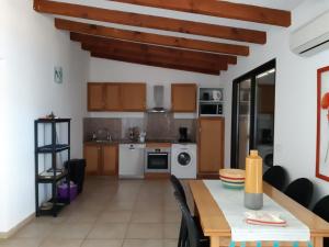 a kitchen with a table and a dining room at Residences La Tonnara in Bonifacio