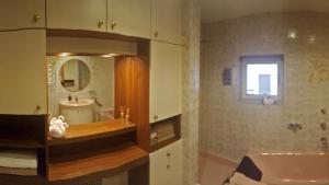a bathroom with a sink and a mirror at Apartments Almstein in Abtenau +30 photos