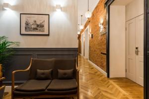 a hallway with a chair and a brick wall at F12 Apartments in Saint Petersburg