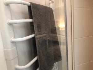 a towel hanging on a towel rack in a shower at Appartment Viola in Brüggen