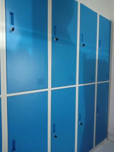 a row of blue lockers in a room at RedDoorz Hostel @ Feliz Noche Cengkareng in Jakarta