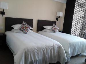 Postel nebo postele na pokoji v ubytování SSAW Boutique Hotel Hefei Intime Centre