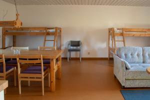 a dining room with a table and chairs and bunk beds at Älvdalens Camping in Älvdalen