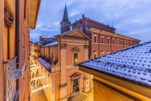 a view of the roofs of buildings and a church at Futura, Bologna by Short Holidays in Bologna