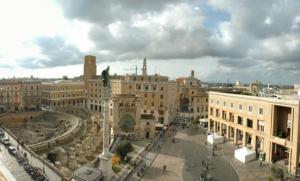 a view of a city with buildings and a statue at B&B Il Sedile in Lecce