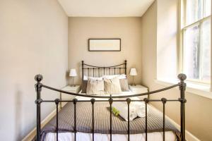 a bedroom with a black bed in a room at JOIVY Amazing Location - Charming Apartment by the Edinburgh Castle! in Edinburgh