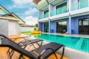 a villa with a swimming pool and a house at The Phu Resort in Pran Buri