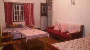a living room with a couch and a table at Vamoose Bhutia Homestay in Padamchen