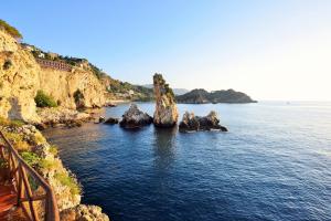 a group of rocks in a body of water at UNA HOTELS Capotaormina in Taormina