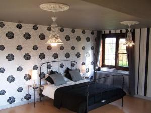 a bedroom with a bed and a wall with flowers at Classic Mansion in Poperinge with Fenced Garden in Poperinge