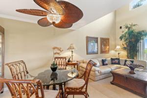 a living room with a table and a couch at Mauna Lani Palm Villas in Waikoloa