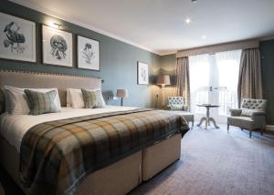 
a hotel room with a large bed and a large window at The Beverley Arms Hotel in Beverley
