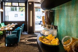 a restaurant with a counter with a bowl of food at Hotel Pilime in Paris
