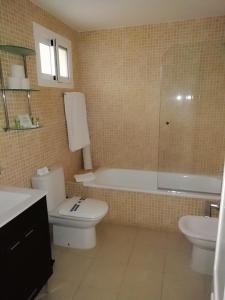 a bathroom with a toilet and a tub and a sink at Club La Costa World Resort in Fuengirola