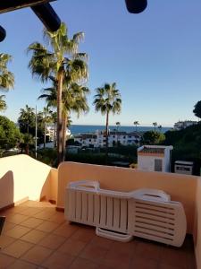 einen Balkon mit Blick auf das Meer und die Palmen in der Unterkunft Club La Costa World Resort in Fuengirola