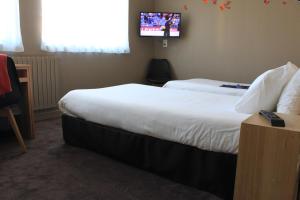 Postel nebo postele na pokoji v ubytování Mon Hotel à Gap