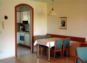 a kitchen and dining room with a table and chairs at Ferienwohnungen am See in Obertrum am See