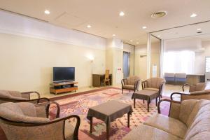 a waiting room with chairs and a flat screen tv at Shimane Hamada Washington Hotel Plaza in Hamada