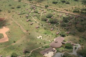 an aerial view of a farm with a river and trees at Kilima Safari Camp in Amboseli