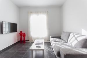 a living room with a couch and a coffee table at Apartamentos Gama in Cala Galdana