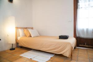 a bedroom with a bed with a black bag on it at El Cerro de la Luna in Arona
