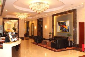 a lobby of a hotel with chairs and a chandelier at Leeden Hotel Guangzhou in Guangzhou