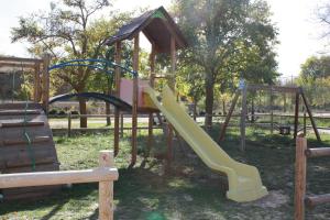 a playground with a slide in a park at Casa La Alegría de La Alcarria I in Torremocha del Campo