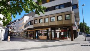 a building on a city street with shops at Cozy-Flats Koblenz in Koblenz