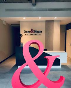 a pink ribbon sign in front of a store at Dom & House - Apartments Waterlane Island in Gdańsk +20 photos