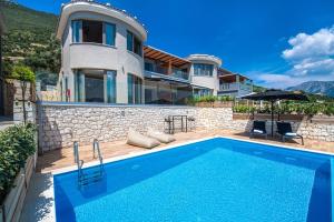 a villa with a swimming pool and a house at Drakatos Villas in Vasiliki