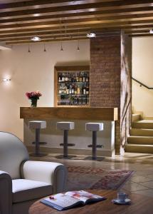 a bar in a room with a brick wall at Ca' Murà Natura e Resort in Maserà di Padova