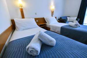 Ένα ή περισσότερα κρεβάτια σε δωμάτιο στο Hotel Alkar