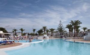 a swimming pool at a resort with people in it at HL Rio Playa Blanca in Playa Blanca