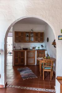 a kitchen with an archway with a table and a dining room at Casas Perla & Maribel in Valle Gran Rey