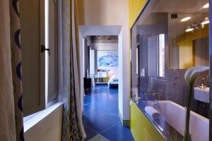 a bathroom with a tub and a sink at Palazzetto Rosso - Art Hotel in Siena +37 photos