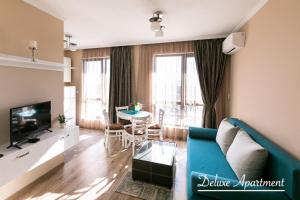 a living room with a blue couch and a table at Apartment Cathedral Deluxe in Varna City