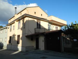 a large white building with a balcony on a street at B&B SAN PIO in Pellezzano