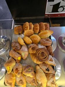 a bunch of different types of pastries on a tray at Rome Together Guest House in Rome