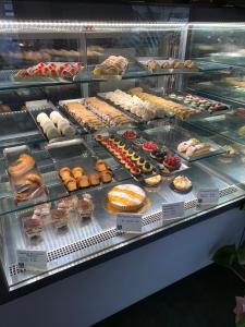 a display case filled with lots of different types of pastries at Rome Together Guest House in Rome