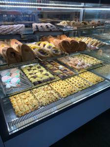 a display case with many different types of pastries at Rome Together Guest House in Rome