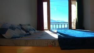 Ένα ή περισσότερα κρεβάτια σε δωμάτιο στο Sunface Homestay