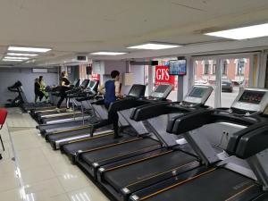 a gym with rows of treadmills and people on them at Viven Mini-Hotel in Moscow