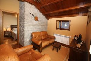 a living room with a couch and a chair at Apartamentos lagunas in Castropol