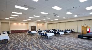 a banquet hall with tables and chairs and a podium at Cobblestone Inn & Suites - Boone in Boone