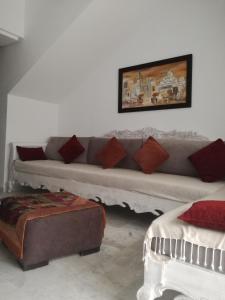 a living room with a couch and a table at Sonny Apartment in Hammamet