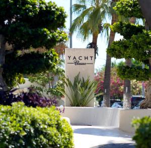 a yatch sign in a park with trees and bushes at Yacht Classic Hotel - Boutique Class in Fethiye +53 photos